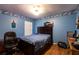 This bedroom features blue walls, wood floors, and a window for natural light at 3701 Barnhouse Pl, Valrico, FL 33596