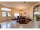 Elegant dining area with tiled floor, a chandelier and a wooden table with seating for six at 3701 Barnhouse Pl, Valrico, FL 33596