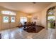 Inviting dining room features tile floors, chandelier, and archway leading to kitchen for seamless entertaining at 3701 Barnhouse Pl, Valrico, FL 33596