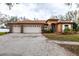 Charming home with three-car garage, well-maintained landscaping, and an inviting facade at 3701 Barnhouse Pl, Valrico, FL 33596