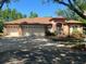 Charming home featuring a three car garage, new roof and a well manicured lawn at 3701 Barnhouse Pl, Valrico, FL 33596