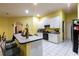 Bright kitchen with white cabinets, bar seating, and modern appliances, offering a delightful cooking experience at 3701 Barnhouse Pl, Valrico, FL 33596
