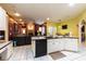 Open kitchen featuring white cabinetry, black appliances, and a view into the adjacent living space at 3701 Barnhouse Pl, Valrico, FL 33596
