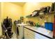This laundry room offers a washer, dryer, storage shelves, utility sink, and ample counter space at 3701 Barnhouse Pl, Valrico, FL 33596