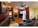 Cozy living room with a brick fireplace, ceiling fan, hardwood floors, and sliding glass doors at 3701 Barnhouse Pl, Valrico, FL 33596