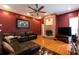 The living room has a brick fireplace, wood floors, and a large, comfortable leather couch at 3701 Barnhouse Pl, Valrico, FL 33596