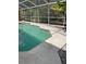Screened in pool area with stone pavers and tropical foliage creating a private backyard oasis at 3701 Barnhouse Pl, Valrico, FL 33596
