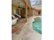 Relax on the covered patio by the screened-in pool, perfect for outdoor living at 3701 Barnhouse Pl, Valrico, FL 33596