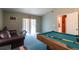 Recreation Room featuring a billiards table, carpet, sliding door and a leather couch at 3701 Barnhouse Pl, Valrico, FL 33596