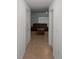 Hallway view leading to living room with leather sofa and coffee table at 37357 Sharks Eye Ln, Zephyrhills, FL 33541