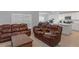 Spacious living room featuring modern furniture, tile floors, lots of natural light, and open-concept design at 37357 Sharks Eye Ln, Zephyrhills, FL 33541