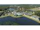 Aerial view of the community amenities, with tennis courts, pools, and lakefront clubhouse at 4507 Majestic Hill Loop, Brooksville, FL 34601