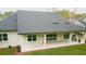 Backyard showing covered patio, outdoor kitchen and well-maintained lawn at 4507 Majestic Hill Loop, Brooksville, FL 34601