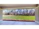 Expansive backyard view from covered patio, showcasing lush lawn and wooded backdrop at 4507 Majestic Hill Loop, Brooksville, FL 34601