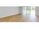 Bright and airy bedroom with hardwood floors and sliding glass doors to the outside at 4507 Majestic Hill Loop, Brooksville, FL 34601