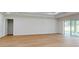 Bright and airy bedroom with hardwood floors, tray ceiling, and sliding glass doors to the outside at 4507 Majestic Hill Loop, Brooksville, FL 34601