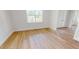Neutral bedroom featuring luxury vinyl plank flooring, white walls, and natural light at 4507 Majestic Hill Loop, Brooksville, FL 34601