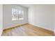 This bright bedroom features beautiful hardwood floors and a large window offering ample natural light at 4507 Majestic Hill Loop, Brooksville, FL 34601