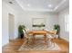 Elegant dining room with modern furnishings, wood floors, and tray ceiling at 4507 Majestic Hill Loop, Brooksville, FL 34601