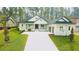 Stunning single-story home with manicured lawn and a paved driveway leading to a two-car garage at 4507 Majestic Hill Loop, Brooksville, FL 34601