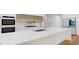 Modern kitchen with white countertops and cabinets, and stainless steel appliances at 4507 Majestic Hill Loop, Brooksville, FL 34601