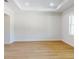 Spacious living room featuring wood-look floors, abundant natural light, and neutral decor at 4507 Majestic Hill Loop, Brooksville, FL 34601
