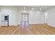 Bright and airy living room with light hardwood floors, white walls, and modern refrigerator at 4507 Majestic Hill Loop, Brooksville, FL 34601
