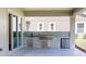 Covered outdoor kitchen area with a built-in grill, sink, and mini fridge at 4507 Majestic Hill Loop, Brooksville, FL 34601