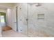 Modern glass shower with rainfall showerhead and designer tile at 4507 Majestic Hill Loop, Brooksville, FL 34601