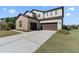 Spacious home featuring a three-car garage, a stone facade, and a wide driveway at 4831 Royal Birkdale Way, Wesley Chapel, FL 33543