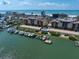 Aerial view of condos with private docks, waterfront access, and nearby beaches at 5301 Gulf Blvd # C202, St Pete Beach, FL 33706