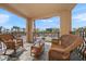 Inviting balcony with wicker seating and a view of nearby palm trees and buildings at 5301 Gulf Blvd # C202, St Pete Beach, FL 33706