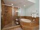 Luxurious bathroom with a glass-enclosed shower and soaking tub at 5301 Gulf Blvd # C202, St Pete Beach, FL 33706