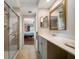 Bright bathroom with glass shower and doorway to bedroom at 5301 Gulf Blvd # C202, St Pete Beach, FL 33706