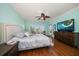Tranquil bedroom with hardwood floors, TV, and a private balcony featuring a water view at 5301 Gulf Blvd # C202, St Pete Beach, FL 33706