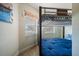 Cozy bedroom with bunk beds, tile floors, and a sunlit window at 5301 Gulf Blvd # C202, St Pete Beach, FL 33706
