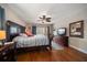 Comfortable bedroom with a large bed, dresser with TV, and sliding glass doors to the balcony at 5301 Gulf Blvd # C202, St Pete Beach, FL 33706