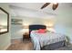 Bright bedroom with a ceiling fan, comfortable king size bed, and bedside tables at 5301 Gulf Blvd # C202, St Pete Beach, FL 33706