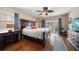 Comfortable bedroom with a large bed, dresser with TV, and sliding glass doors to the balcony at 5301 Gulf Blvd # C202, St Pete Beach, FL 33706