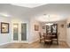 Traditional dining area with a glass display cabinet and seating for four at 5301 Gulf Blvd # C202, St Pete Beach, FL 33706