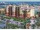 Exterior of a modern condo building with tropical landscaping and ample parking at 5301 Gulf Blvd # C202, St Pete Beach, FL 33706