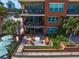 Spacious patio area with outdoor seating, lush greenery, and views of the city skyline at 5301 Gulf Blvd # C202, St Pete Beach, FL 33706