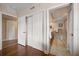 Hallway area with closet doors that lead to a bathroom featuring a tub and shower at 5301 Gulf Blvd # C202, St Pete Beach, FL 33706