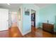 Hallway view with hardwood floors leading to the bathroom and walk-in closet at 5301 Gulf Blvd # C202, St Pete Beach, FL 33706
