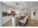 Kitchen features stainless steel appliances, counter seating, and views into other living spaces at 5301 Gulf Blvd # C202, St Pete Beach, FL 33706