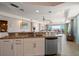 Open-concept kitchen with granite counters and breakfast bar, offering views of the living area and waterfront balcony at 5301 Gulf Blvd # C202, St Pete Beach, FL 33706