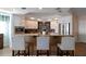 Kitchen featuring counter seating, stainless appliances, tiled backsplash, and granite counters at 5301 Gulf Blvd # C202, St Pete Beach, FL 33706