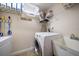 Well-organized laundry room with washer, dryer, sink, and shelving for storage at 5301 Gulf Blvd # C202, St Pete Beach, FL 33706