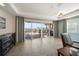 Living room with a view of the ocean and a patio area with a dining table and grill at 5301 Gulf Blvd # C202, St Pete Beach, FL 33706
