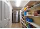 Pantry with stainless steel refrigerator and ample shelving at 5301 Gulf Blvd # C202, St Pete Beach, FL 33706